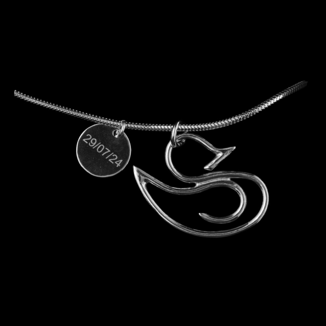 Sterling silver duck necklace made from circular wire with a smaller circle with a special date engraved on it. A jewellery commission by NI silver