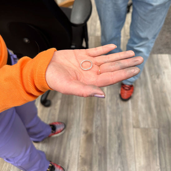 Handmade rings are a popular thing to make on our NI Silver jewellery making experiences and here a lady holds out her hand to show the silver ring that she has just made.
