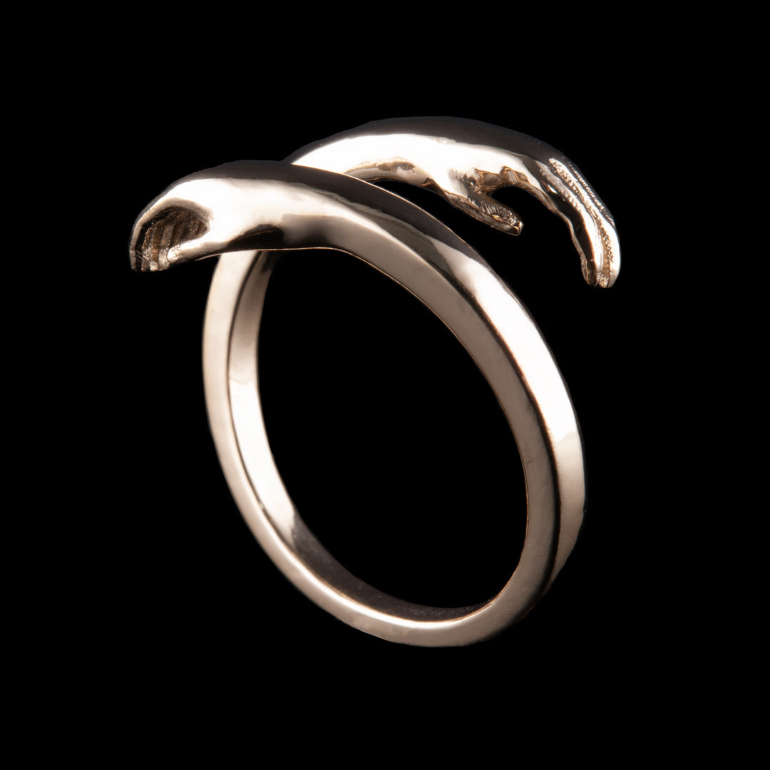 Hug Gold ring commission made by NI Silver jewellery out of 9ct gold, this ring design has a simple band in both directions for about 3/4 of the ring and then it splits with 2 human hands at the ends. A lovely bespoke jewellery commission.