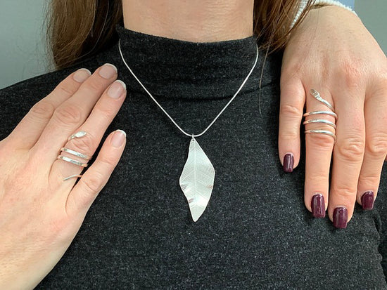 Leaf necklace and snakes shown on a model, made in NI Silver jewellery making experiences.