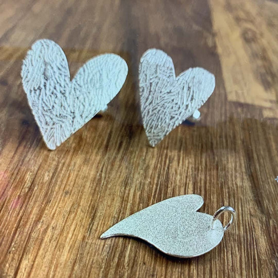 Shows silver love heart jewellery, handmade pendant with matching love heart cufflinks.