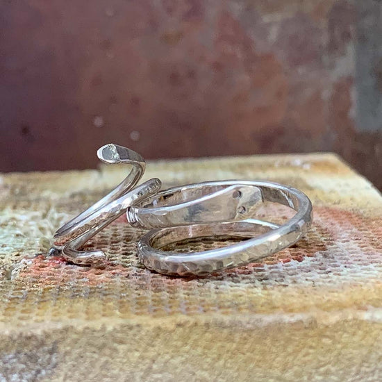 2 silver handmade rings with different textures on them.  You can make these yourself in the NI SIlver jewellery making experiences in Northern Ireland.