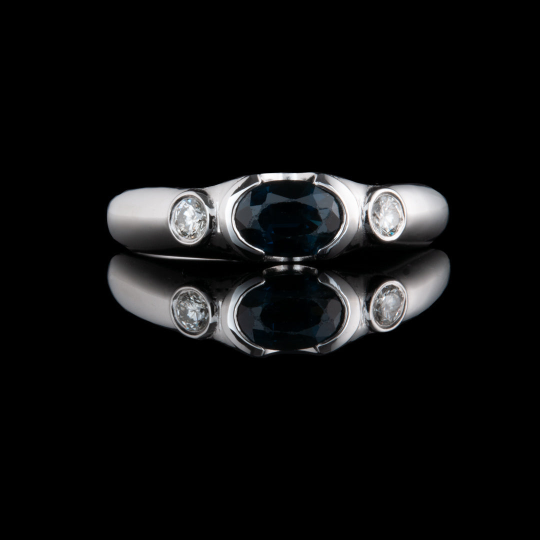 Stunning white gold ring with a central sapphire with 2 lovely diamonds, on each side. A classic piece of bespoke jewellery by NI Silver.