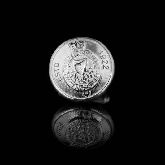 A face on view of one of the RUC button cufflinks made out of silver.