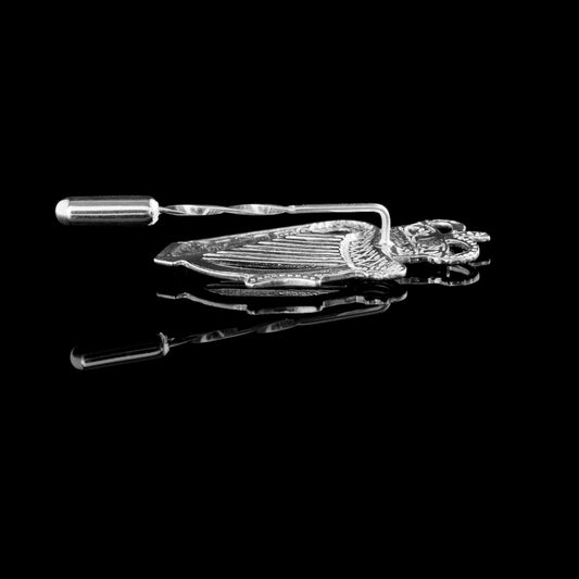 This shows the reverse side of the RUC cap badge with the long pin used to attach it to a lapel.