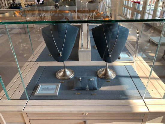 NI Silver Jewellery Display at Hillsborough Castle Gift Shop - Pineapple and Lady Alice Temple necklaces with matching charms in front of them.