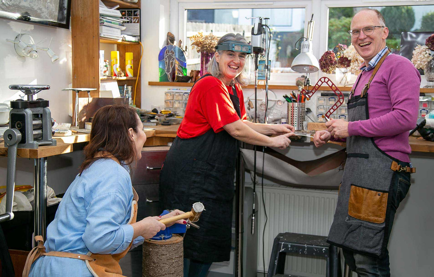 Ruth and Steve smiling as they host a jewellery making experience in our workshop.