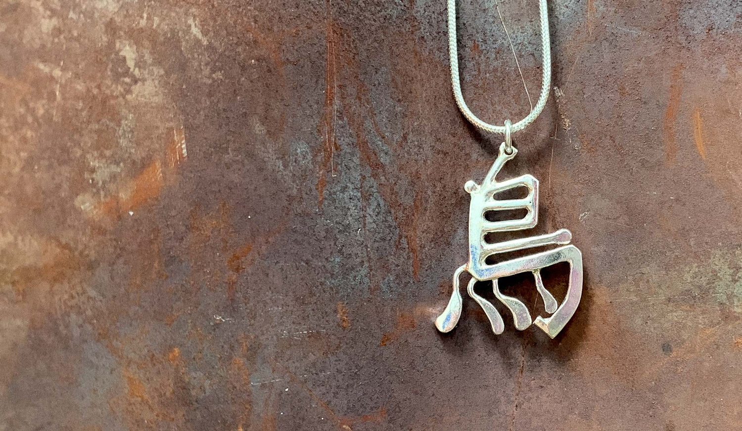 NI Silver creates lovely bespoke commission jewellery to your design, shown here is a Japanese symbol necklace.