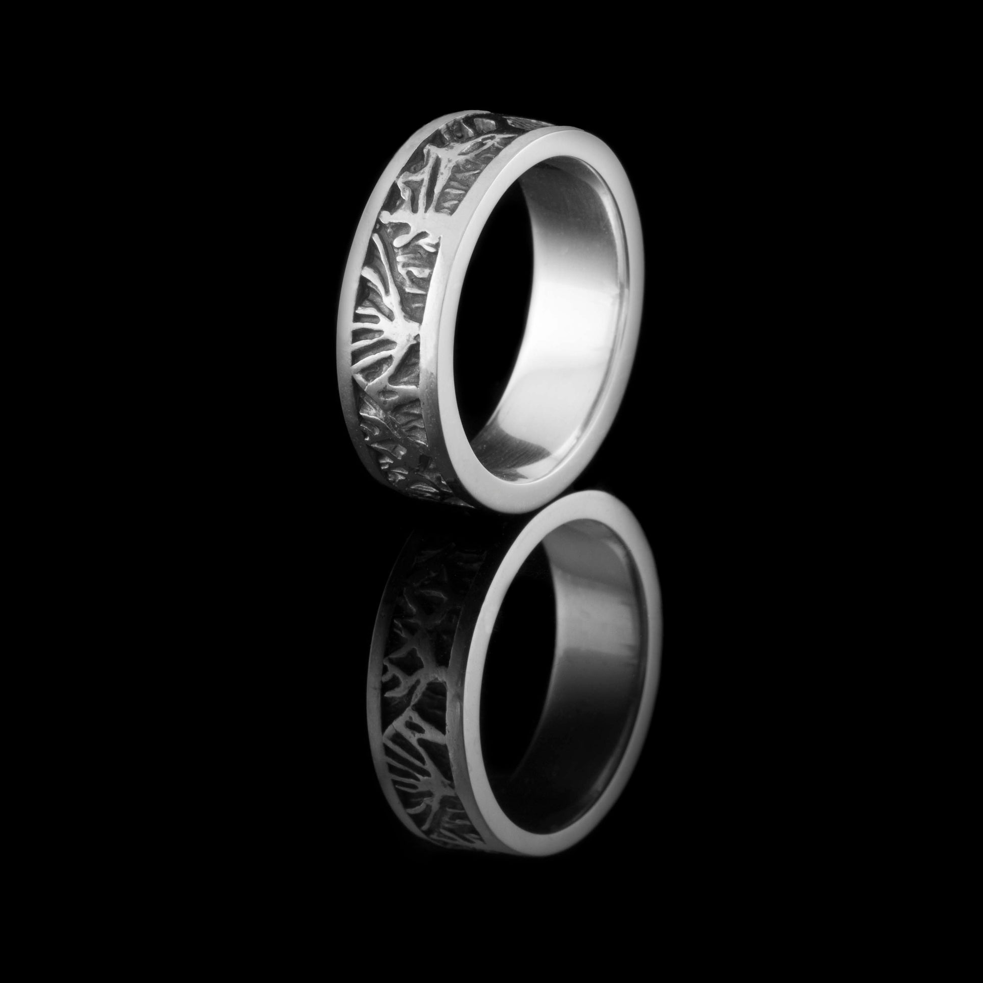 NI Silver's Dark Hedges ring commission produced this lovely solid silver ring.  With a top and bottom band flowing around the ring the space between them is where the trees shaped exist all the way around. The background of the trees has been oxidised so it looks black.