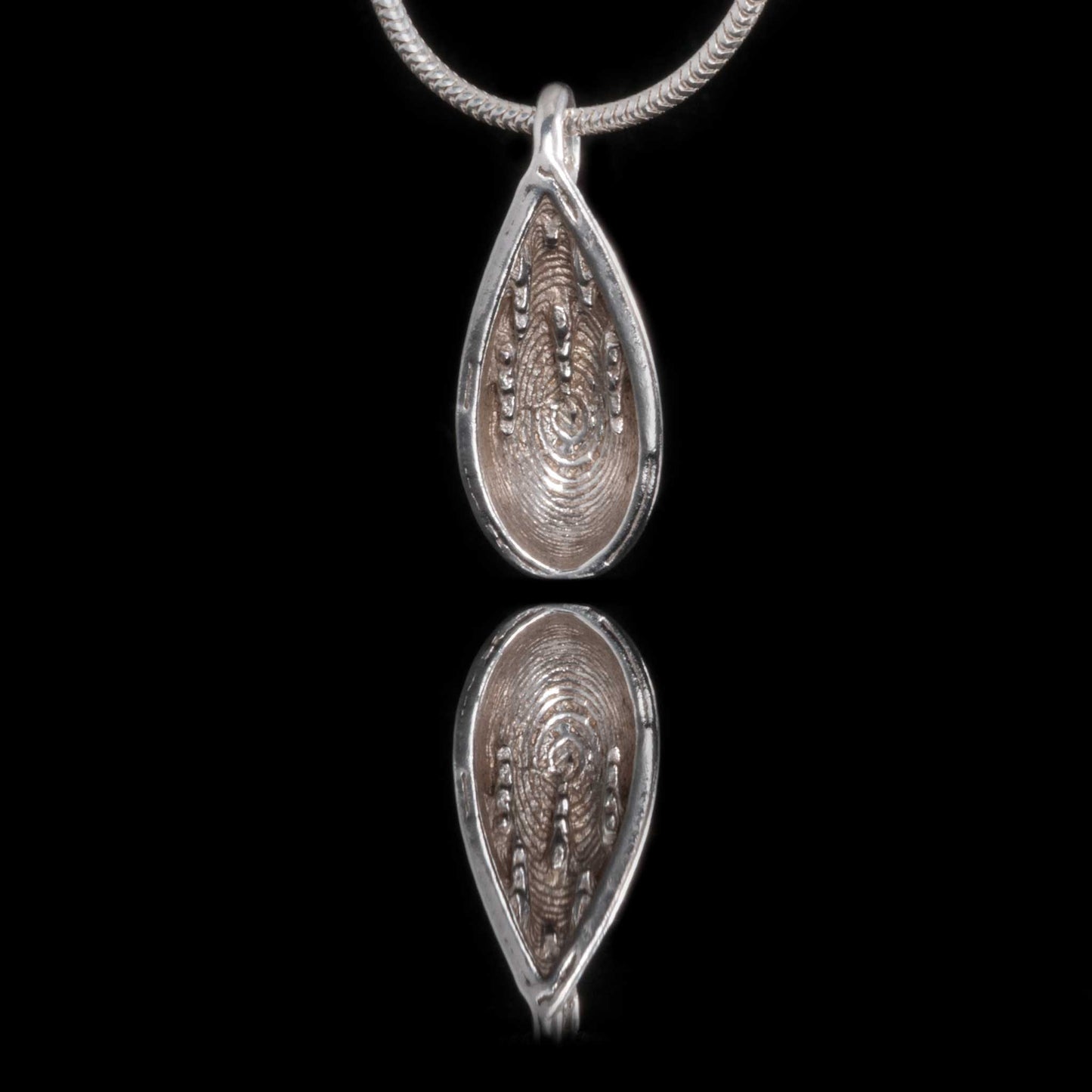 Marble Arch Caves Silver Necklace on a silver snake chain. A water drop pendant with Stalactites inside.