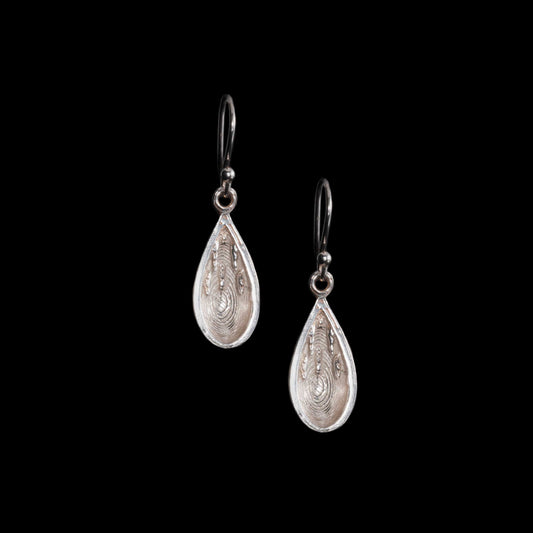 Mable Arch Cave Silver Earrings in the shape of water drops with a concave inner which has Stalactites flowing down. Sterling Silver drop style of earrings.