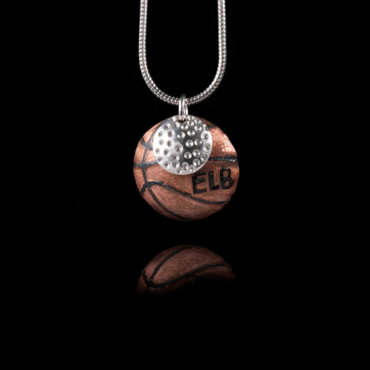 A basketball and golf ball necklace on a silver chain