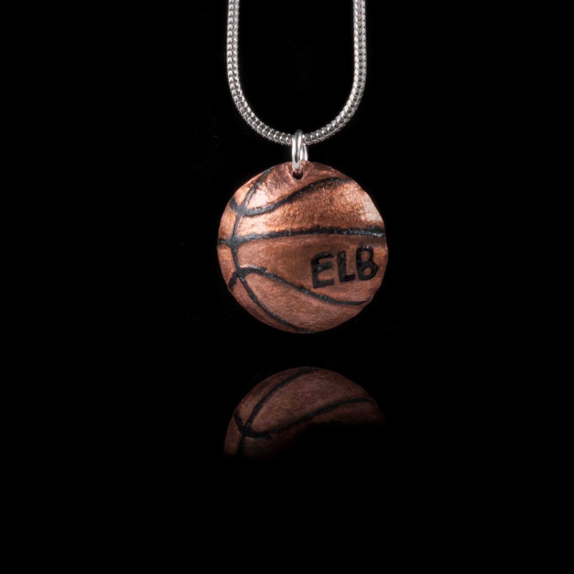 A basketball necklace on a silver chain