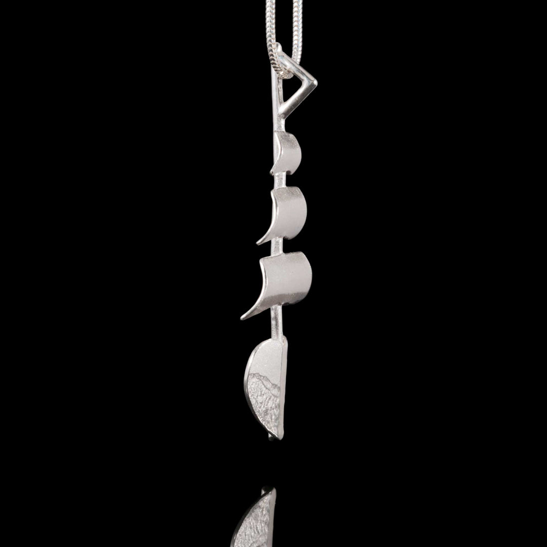 Side profile of our Tall Ships silver necklace.